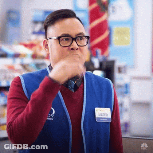 A Man Wearing Glasses And A Vest Is Making A Funny Face . GIF