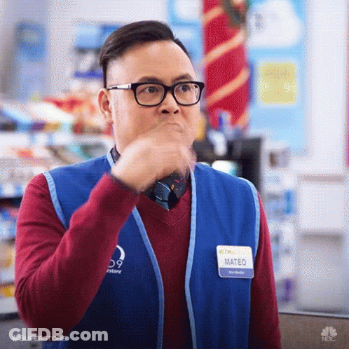 A Man Wearing Glasses And A Vest Is Making A Funny Face . GIF
