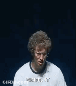 A Man Wearing Glasses And A Watch Is Making A Funny Face With His Hands . GIF