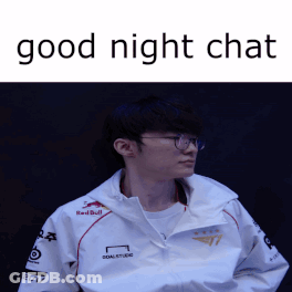 A Man Wearing Glasses And A White Jacket With Red Bull Written On It GIF