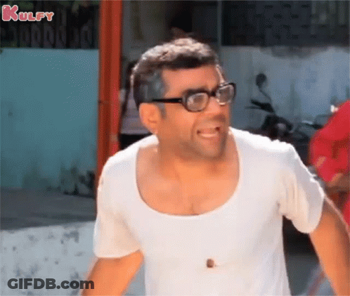 A Man Wearing Glasses And A White Shirt Is Laughing . GIF