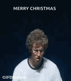 A Man Wearing Glasses And A White Shirt Is Making A Funny Face With His Hands In The Air . GIF