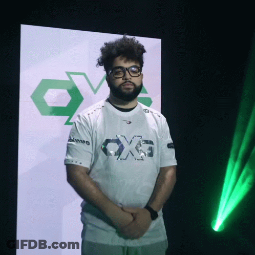 A Man Wearing Glasses And A White Shirt That Says Ox6 GIF