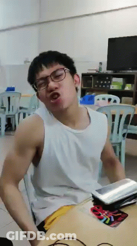 A Man Wearing Glasses And A White Tank Top Is Making A Funny Face GIF