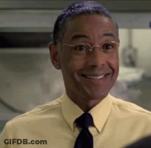 A Man Wearing Glasses And A Yellow Shirt And Tie Is Smiling GIF