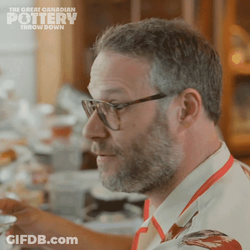 A Man Wearing Glasses And An Apron With The Words The Great Canadian Pottery Throw Down On The Bottom GIF