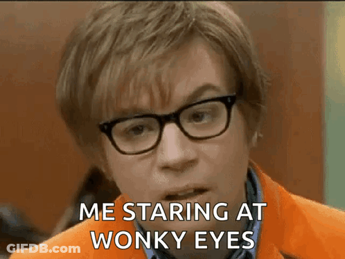 A Man Wearing Glasses And An Orange Jacket Is Making A Funny Face And Saying `` Me Staring At Wonky Eyes '' . GIF