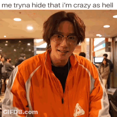 A Man Wearing Glasses And An Orange Jacket That Says Palace On It GIF