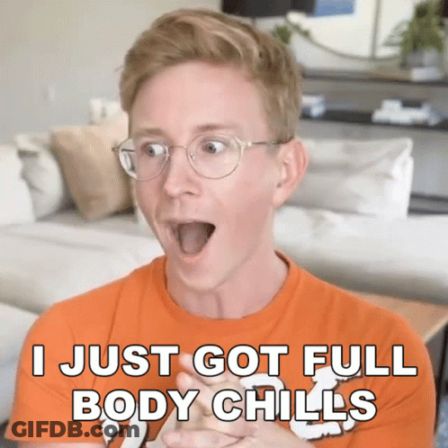 A Man Wearing Glasses And An Orange Shirt Says I Just Got Full Body Chills GIF