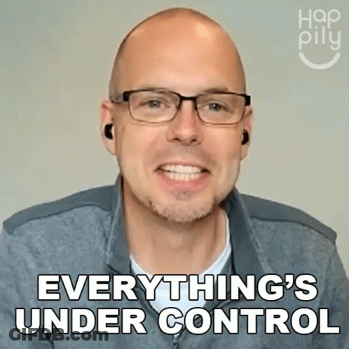 A Man Wearing Glasses And Ear Buds Is Smiling And Says Everything 'S Under Control GIF