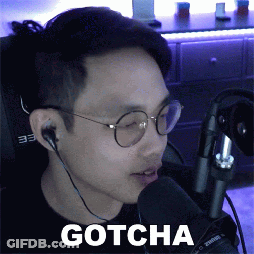 A Man Wearing Glasses And Ear Buds Says Gotcha GIF