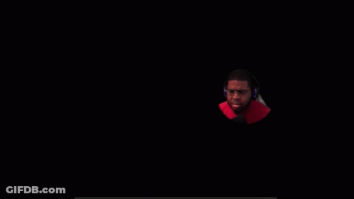A Man Wearing Glasses And Headphones Is Looking At The Camera GIF
