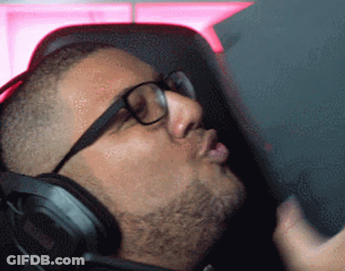 A Man Wearing Glasses And Headphones Is Looking Down GIF