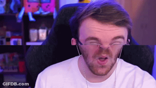 A Man Wearing Glasses And Headphones Is Making A Funny Face . GIF