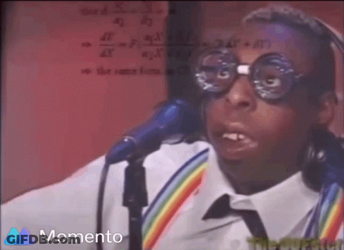 A Man Wearing Glasses And Headphones Is Singing Into A Microphone And The Word Momento Is On The Bottom GIF