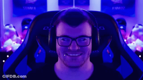 A Man Wearing Glasses And Headphones Is Sitting In A Dxracer Gaming Chair GIF