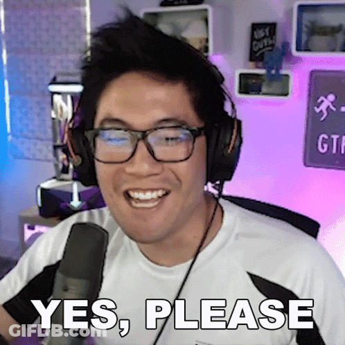 A Man Wearing Glasses And Headphones Is Smiling And Says Yes Please GIF