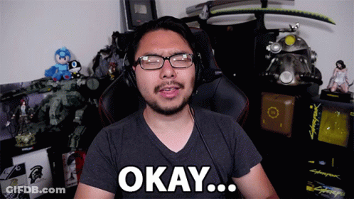 A Man Wearing Glasses And Headphones Says Okay In Front Of A Cyberpunk Game GIF