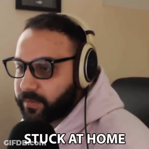 A Man Wearing Glasses And Headphones Says " Stuck At Home " GIF