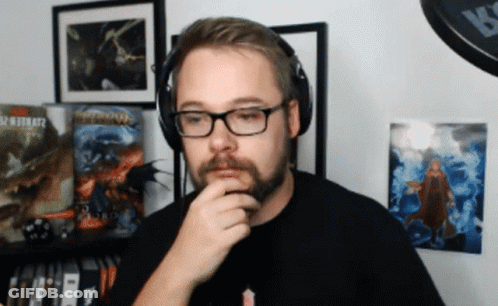 A Man Wearing Glasses And Headphones Stands In Front Of A Wall With A Picture Of A Dragon On It GIF