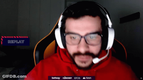A Man Wearing Glasses And Headphones With A Replay Sign In The Corner GIF