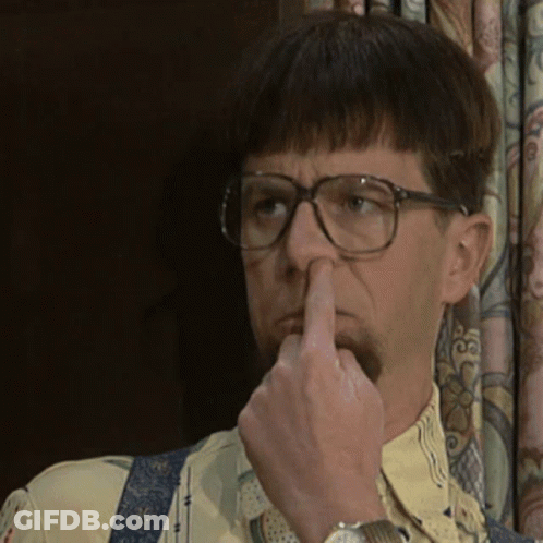 A Man Wearing Glasses And Suspenders Is Holding His Nose GIF