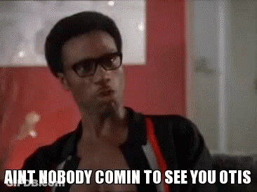 A Man Wearing Glasses And Suspenders Is Sitting On A Couch And Talking To Someone . GIF