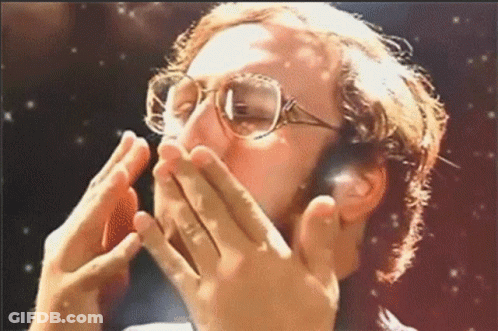 A Man Wearing Glasses Covers His Mouth With His Hands GIF