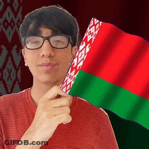 A Man Wearing Glasses Holds A Red Green And White Flag In Front Of His Face GIF