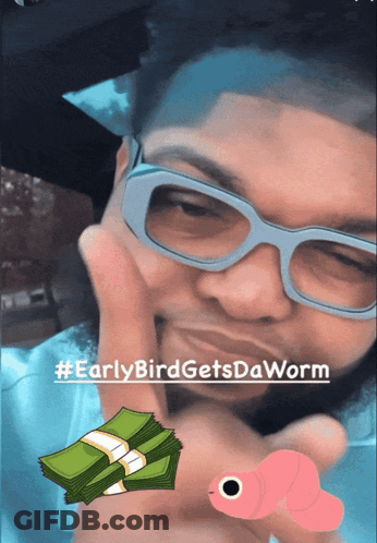 A Man Wearing Glasses Holds A Stack Of Money And A Worm GIF