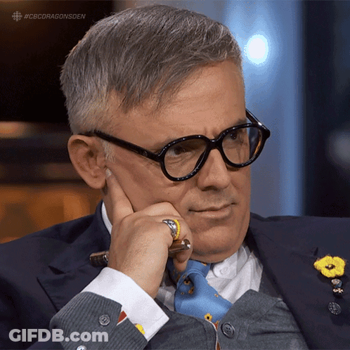 A Man Wearing Glasses Holds His Hand To His Chin With The Hashtag #Cbcdragonsden GIF
