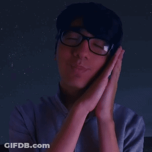 A Man Wearing Glasses Holds His Hands To His Face In Prayer GIF