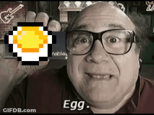 A Man Wearing Glasses Holds Up A Pixelated Egg With The Word Egg Below It GIF