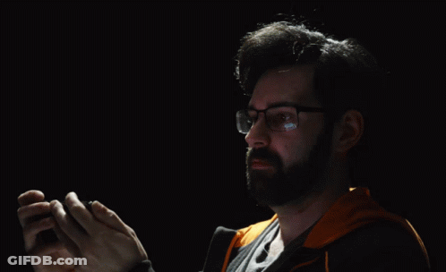 A Man Wearing Glasses Is Clapping His Hands In Front Of A Black Background That Says My Eyes GIF