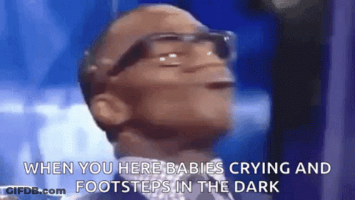 A Man Wearing Glasses Is Crying In The Dark . GIF