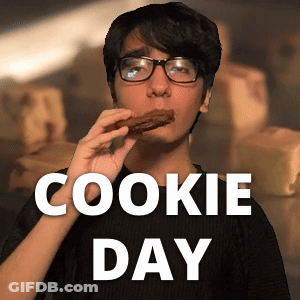 A Man Wearing Glasses Is Eating A Cookie With The Words Cookie Day Behind Him GIF
