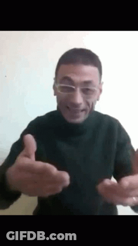 A Man Wearing Glasses Is Giving A Thumbs Up Sign . GIF