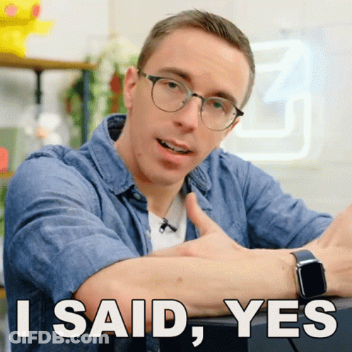 A Man Wearing Glasses Is Giving A Thumbs Up With The Words I Said Yes Below Him GIF