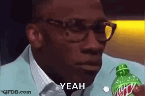 A Man Wearing Glasses Is Holding A Bottle Of Mountain Dew And Saying `` Yeah '' . GIF
