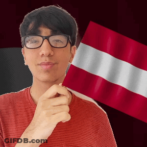 A Man Wearing Glasses Is Holding A Flag In Front Of His Face GIF