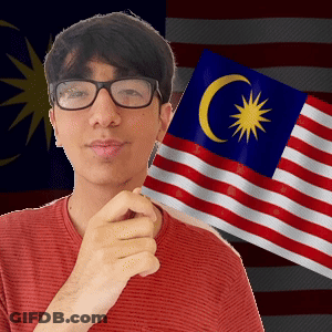 A Man Wearing Glasses Is Holding A Flag With A Crescent Moon And Star On It GIF