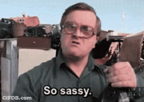 A Man Wearing Glasses Is Holding A Gun And Saying So Sassy . GIF