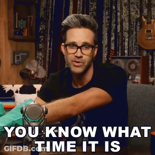 A Man Wearing Glasses Is Holding A Microphone And Says " You Know What Time It Is " GIF