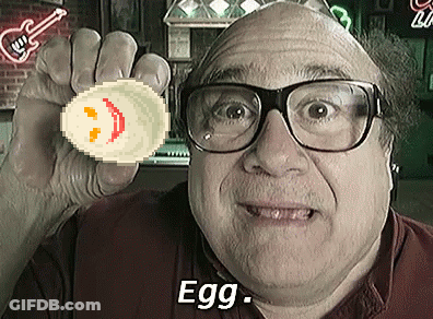 A Man Wearing Glasses Is Holding Up A Pixelated Egg With A Smiley Face On It And The Words Egg Below Him GIF