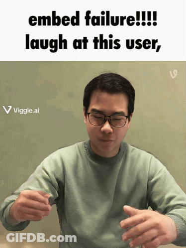 A Man Wearing Glasses Is Laughing At A Failed Embed GIF