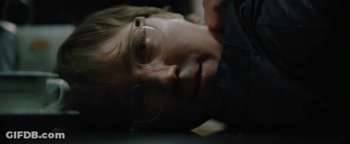 A Man Wearing Glasses Is Laying Down With His Eyes Closed GIF