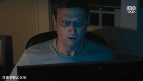 A Man Wearing Glasses Is Looking At A Computer Screen With Hbo Max Written On The Bottom GIF