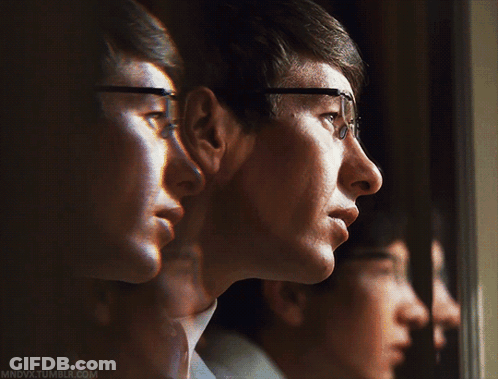 A Man Wearing Glasses Is Looking Out A Window And The Website Mndvx.tumblr.com Is Visible GIF