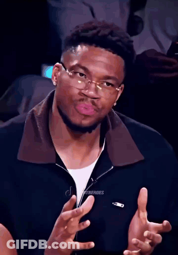 A Man Wearing Glasses Is Making A Funny Face GIF