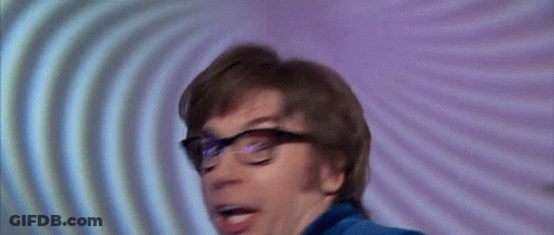 A Man Wearing Glasses Is Making A Funny Face GIF